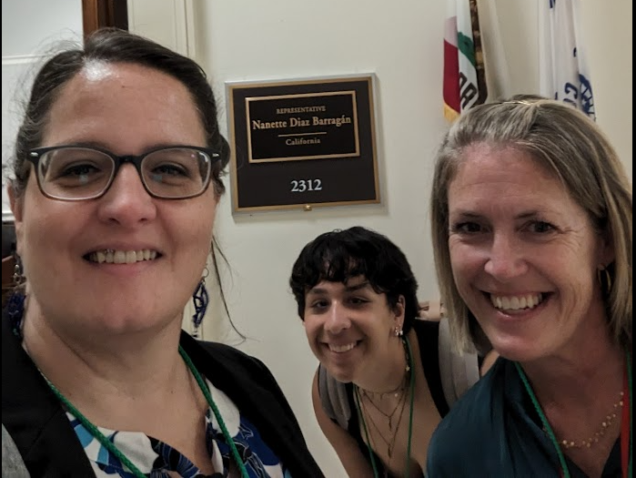 Three people in front of legislator office in Washington D.C.